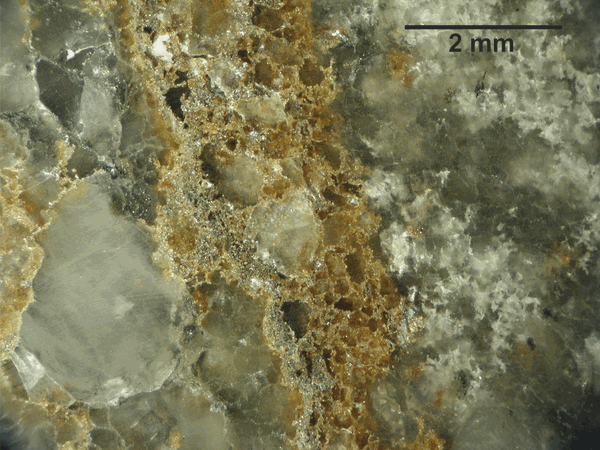The Nadok ore body at Laisvall is particularly rich in sphalerite (ZnS). Rounded quartz grains of different sizes are cemented by sphalerite (yellowish). Scale bar is 2mm